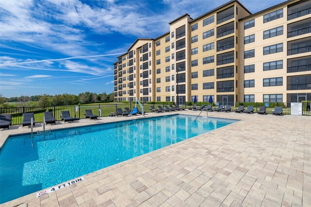 pool featuring a patio area and fence