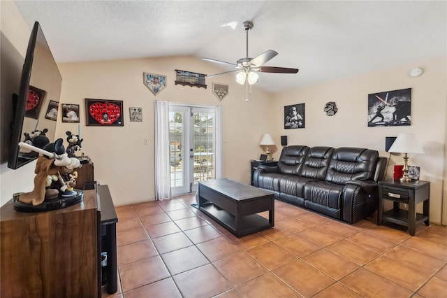 living area with french doors, light tile patterned floors, lofted ceiling, a ceiling fan, and a textured ceiling