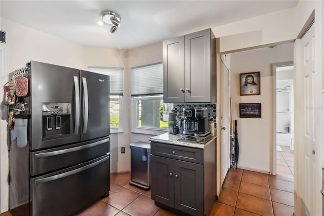 kitchen with gray cabinets, black fridge with ice dispenser, and tile patterned floors