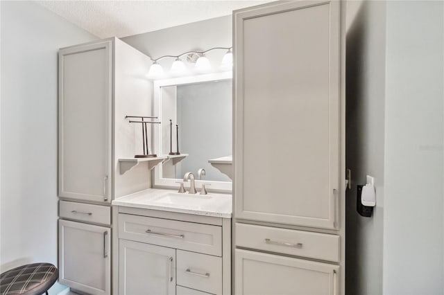 bathroom with a textured ceiling and vanity