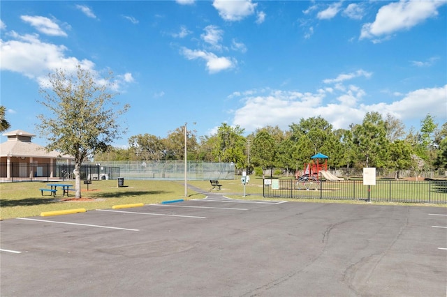 uncovered parking lot with fence and playground community