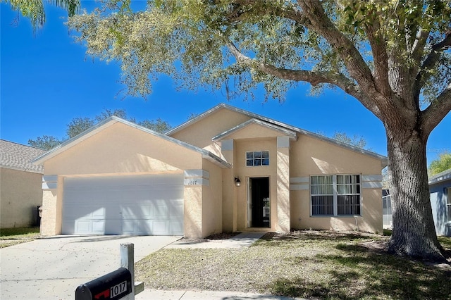 ranch-style home with an attached garage, driveway, and stucco siding