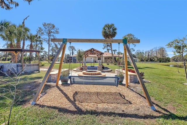 view of playground with a fire pit and a lawn