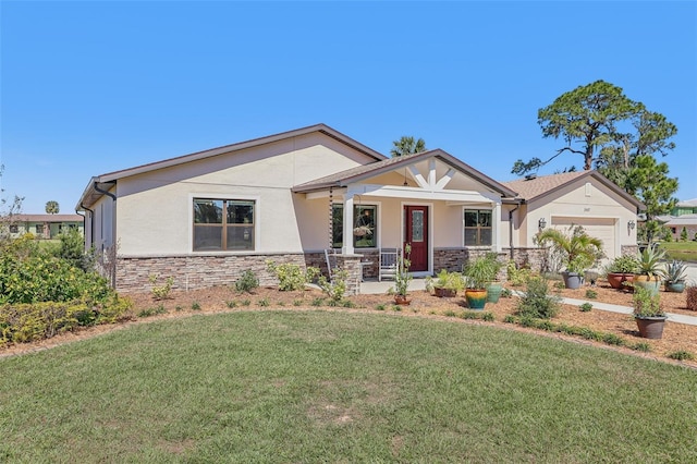 view of front of property with an attached garage, stone siding, a front yard, and stucco siding