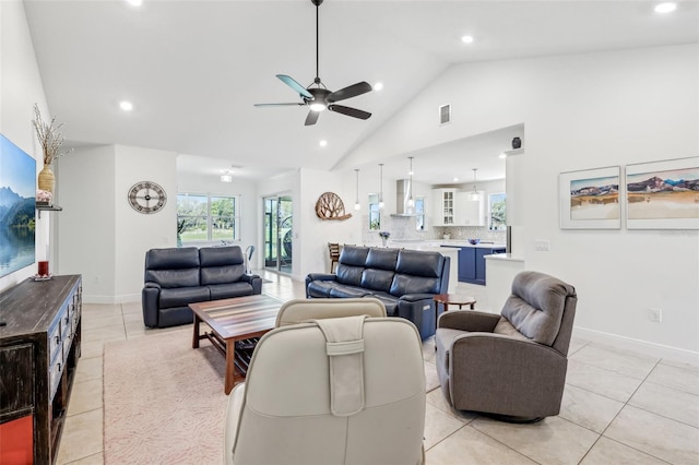 living area featuring light tile patterned floors, high vaulted ceiling, visible vents, and a wealth of natural light