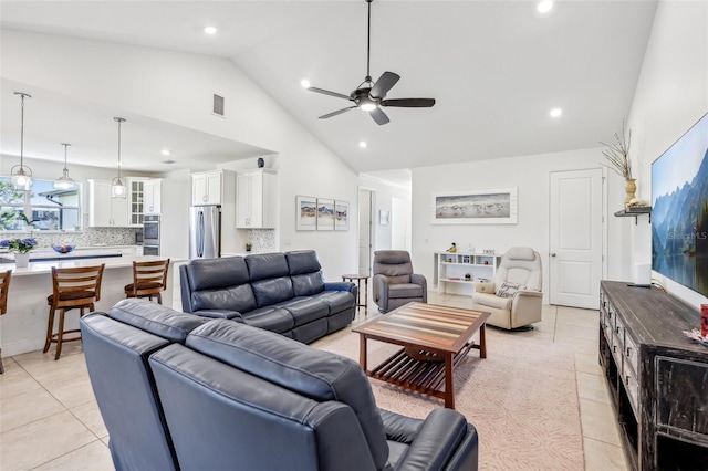 living area featuring high vaulted ceiling, light tile patterned flooring, recessed lighting, visible vents, and a ceiling fan