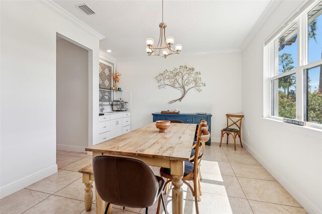 dining area featuring light tile patterned floors, visible vents, baseboards, crown molding, and a notable chandelier