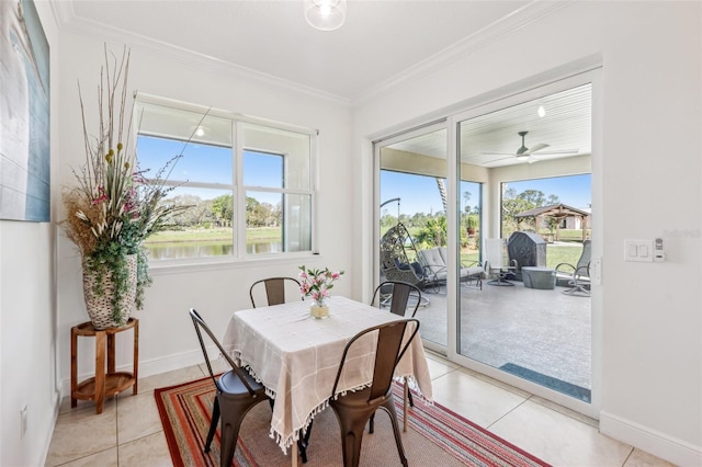 dining space with plenty of natural light, baseboards, crown molding, and light tile patterned flooring