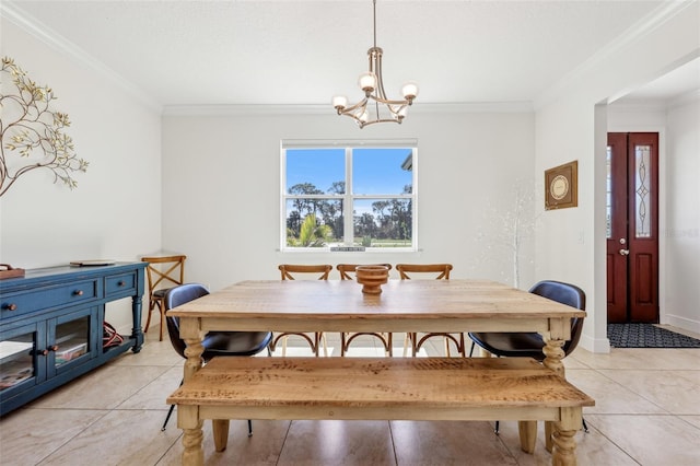 dining space with ornamental molding, an inviting chandelier, and light tile patterned floors