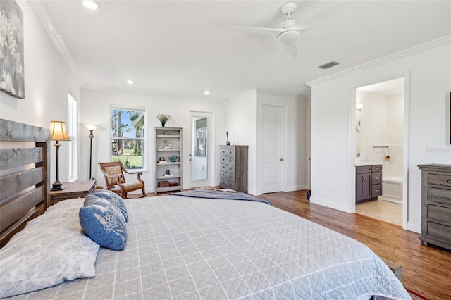 bedroom with a fireplace, recessed lighting, visible vents, ornamental molding, and light wood-type flooring