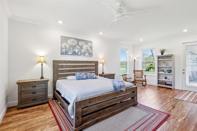 bedroom featuring light wood-style flooring, baseboards, crown molding, and recessed lighting