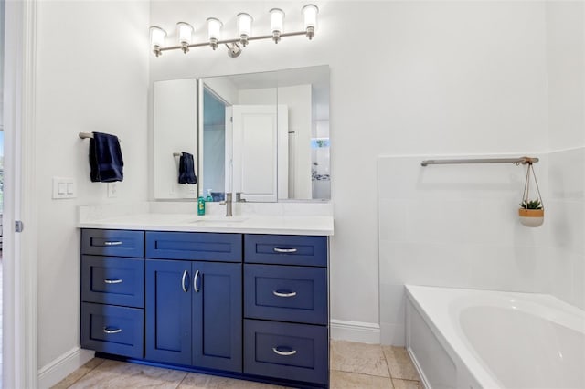 full bathroom featuring a washtub, vanity, and baseboards