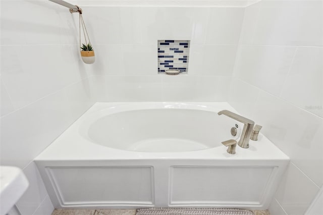 full bathroom featuring tile walls and a bath