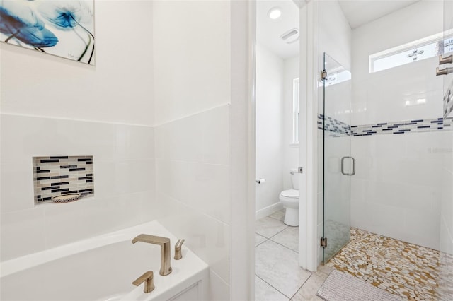 full bathroom featuring tile patterned flooring, toilet, visible vents, a shower stall, and a bath