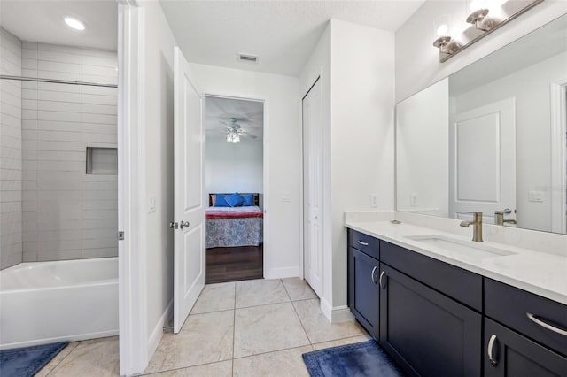 full bathroom featuring vanity, baseboards, visible vents, tile patterned floors, and ensuite bath