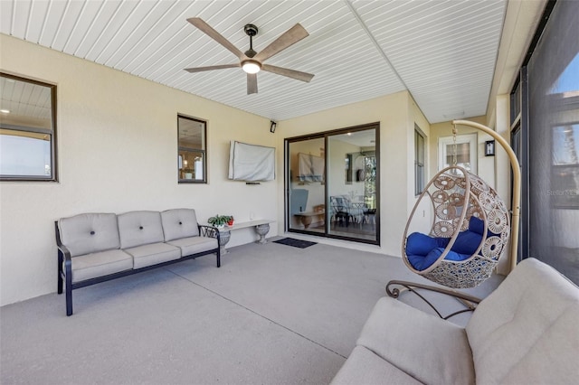 sunroom / solarium featuring ceiling fan