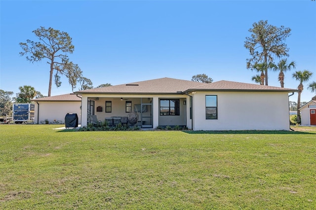 view of front of property featuring a front lawn and stucco siding