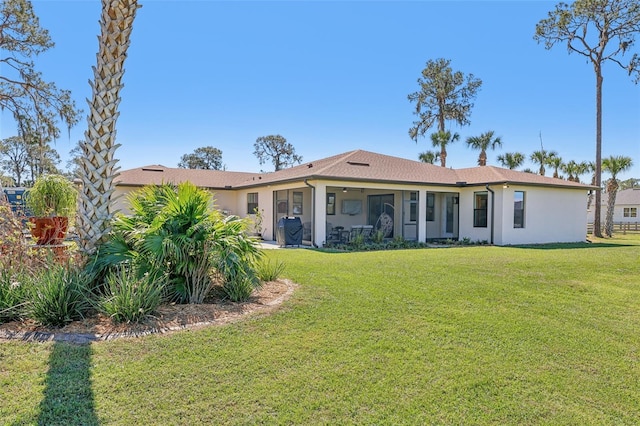 view of front of house featuring a front lawn and stucco siding