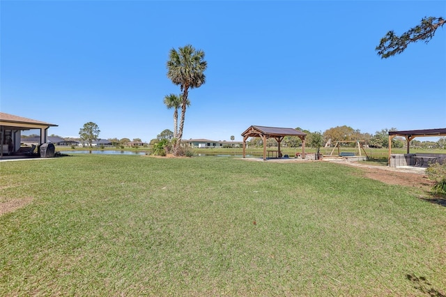 view of yard featuring a gazebo and a water view