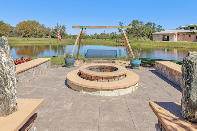 view of patio featuring an outdoor fire pit and a water view