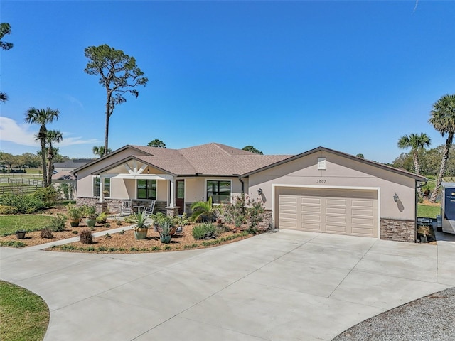 view of front of property with a garage, stone siding, driveway, and stucco siding