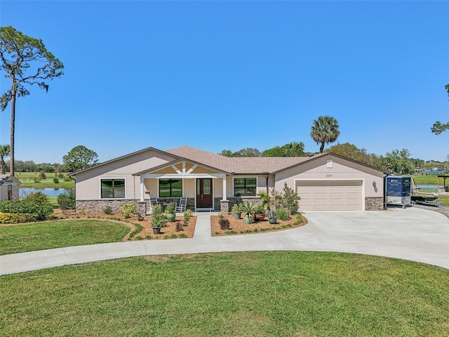 single story home with driveway, a garage, stone siding, covered porch, and a front lawn