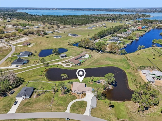 birds eye view of property with a water view and a residential view