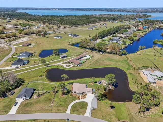 drone / aerial view featuring a water view and a residential view