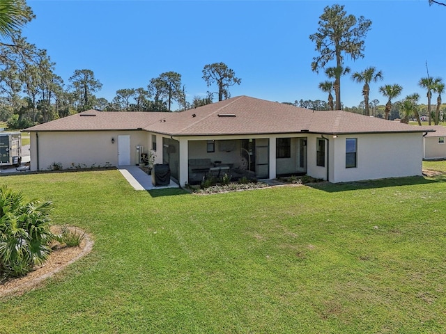 back of house with a lawn and stucco siding