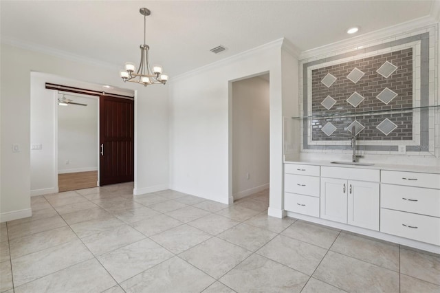 3607 Hidden River Ln, Tavares, FL 32778 - unfurnished dining area featuring a sink, crown molding, a chandelier, baseboards, and a barn door