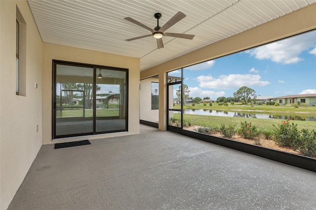 3607 Hidden River Ln, Tavares, FL 32778 - unfurnished sunroom featuring ceiling fan, a water view, and speckle patterned floor