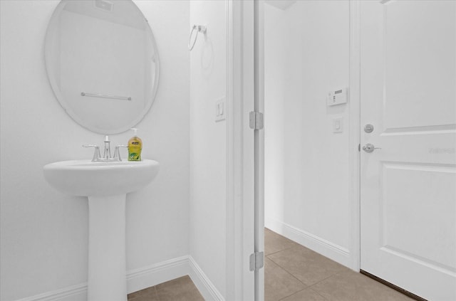 bathroom featuring tile patterned flooring and baseboards