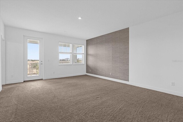 carpeted empty room with recessed lighting and baseboards