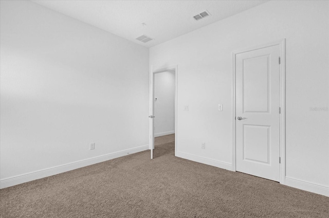 interior space featuring baseboards, visible vents, and carpet flooring