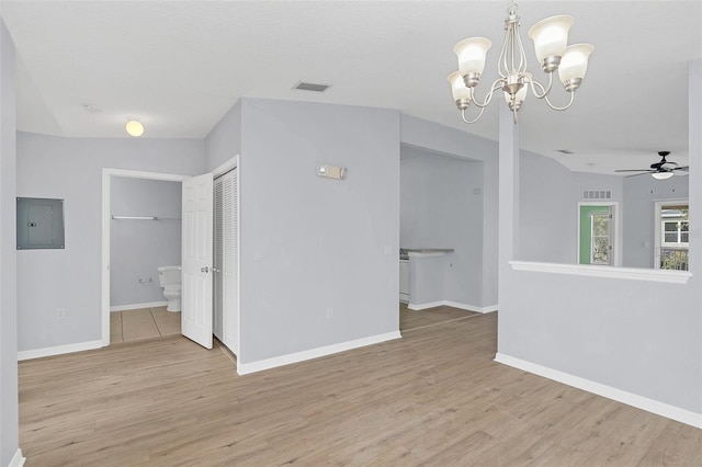 unfurnished room featuring electric panel, visible vents, baseboards, and wood finished floors