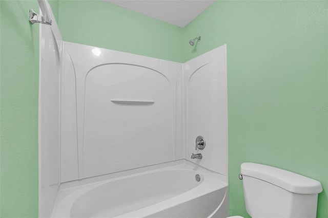 full bathroom featuring a textured ceiling,  shower combination, and toilet