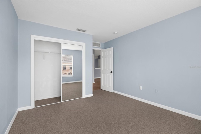 unfurnished bedroom with carpet floors, visible vents, and a closet