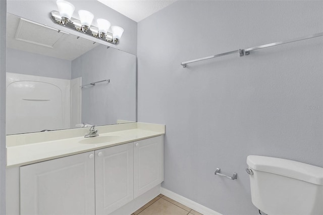 bathroom featuring baseboards, vanity, toilet, and tile patterned floors