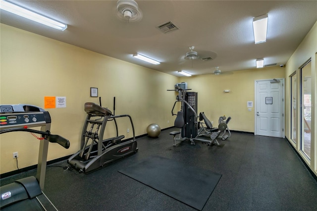 exercise room with baseboards and visible vents