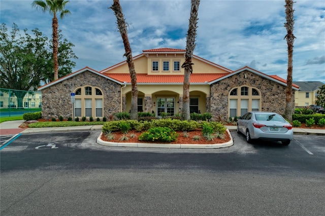 view of building exterior with uncovered parking