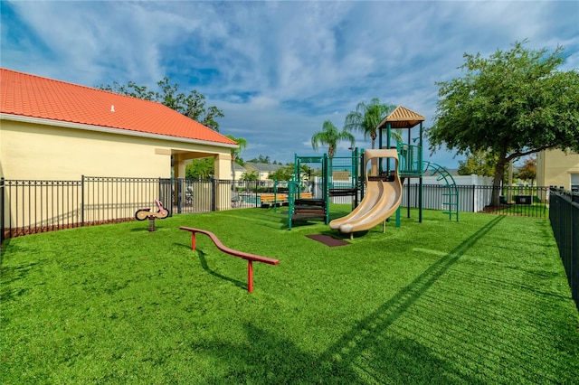 community play area with a yard and fence