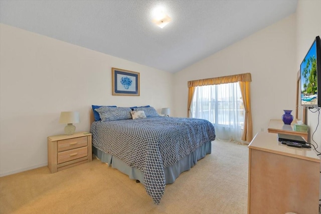 bedroom featuring lofted ceiling, a textured ceiling, and light colored carpet