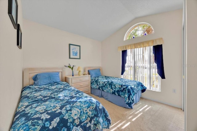 bedroom with carpet floors and vaulted ceiling