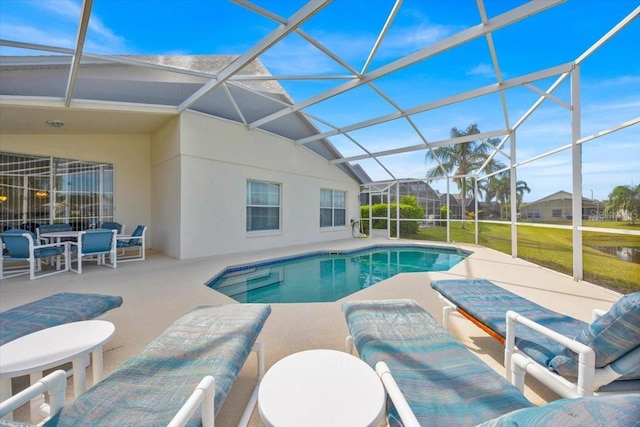 pool featuring a patio and glass enclosure