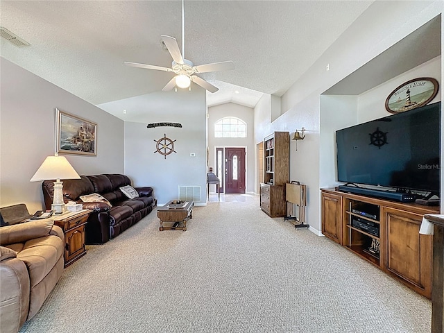 living area featuring visible vents, high vaulted ceiling, light carpet, a textured ceiling, and a ceiling fan