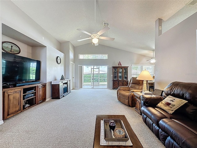 living area featuring visible vents, light carpet, a textured ceiling, and a ceiling fan