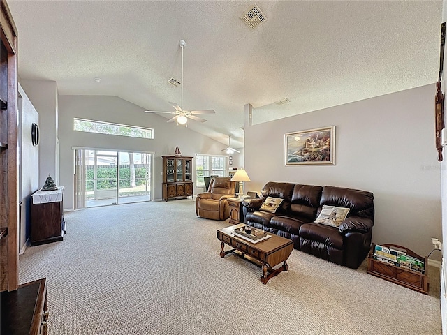 living room featuring a ceiling fan, visible vents, carpet floors, and a textured ceiling