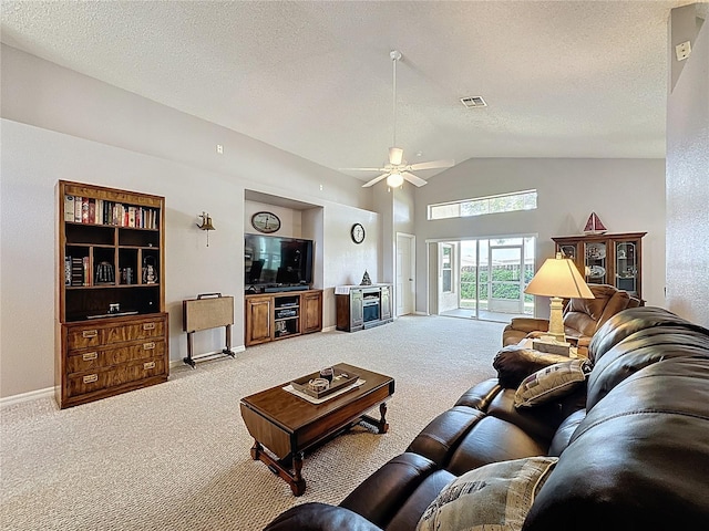 living room featuring visible vents, ceiling fan, light colored carpet, lofted ceiling, and a textured ceiling