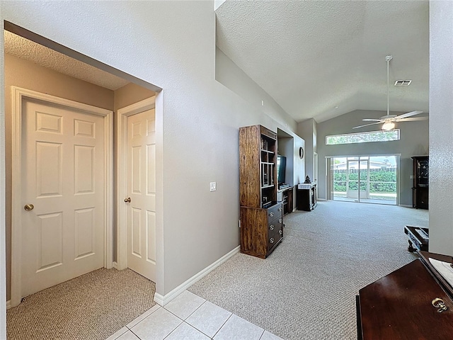 living room with visible vents, lofted ceiling, light colored carpet, and a textured ceiling