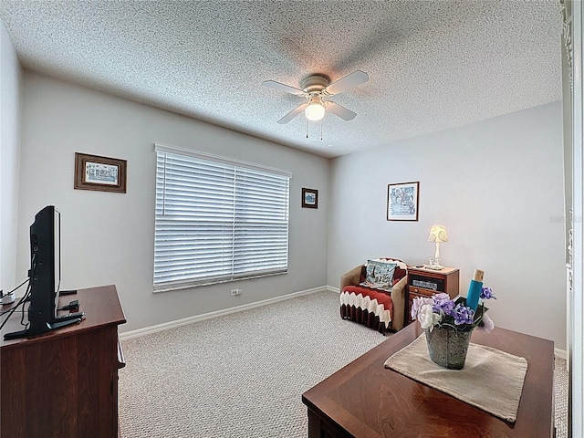 interior space with baseboards, carpet flooring, a textured ceiling, and ceiling fan